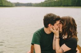 couple kissing in rowboat