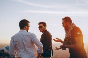 three men standing while laughing 1049317